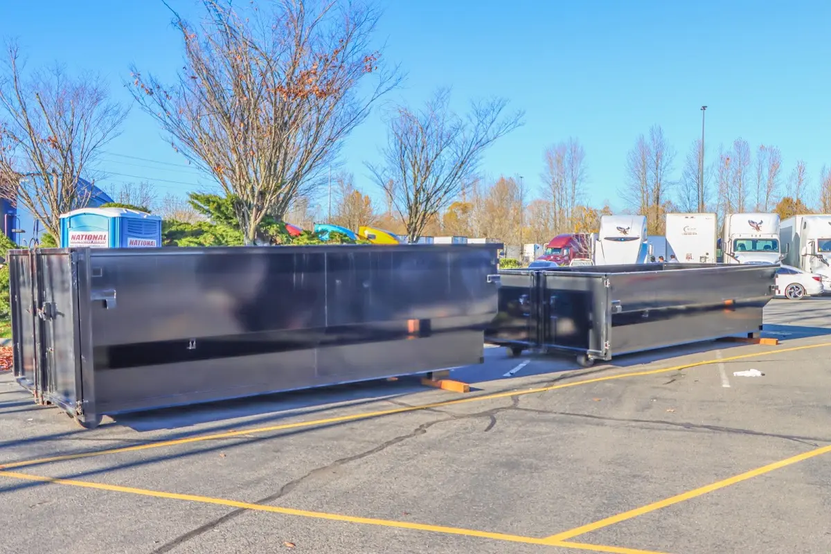 Professional dumpster rental service with roll-off container on residential driveway in Upland